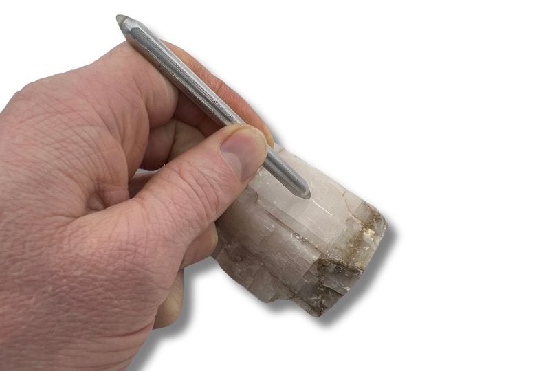 A hardness test in which a scratch is made in calcite using a hardness pen.